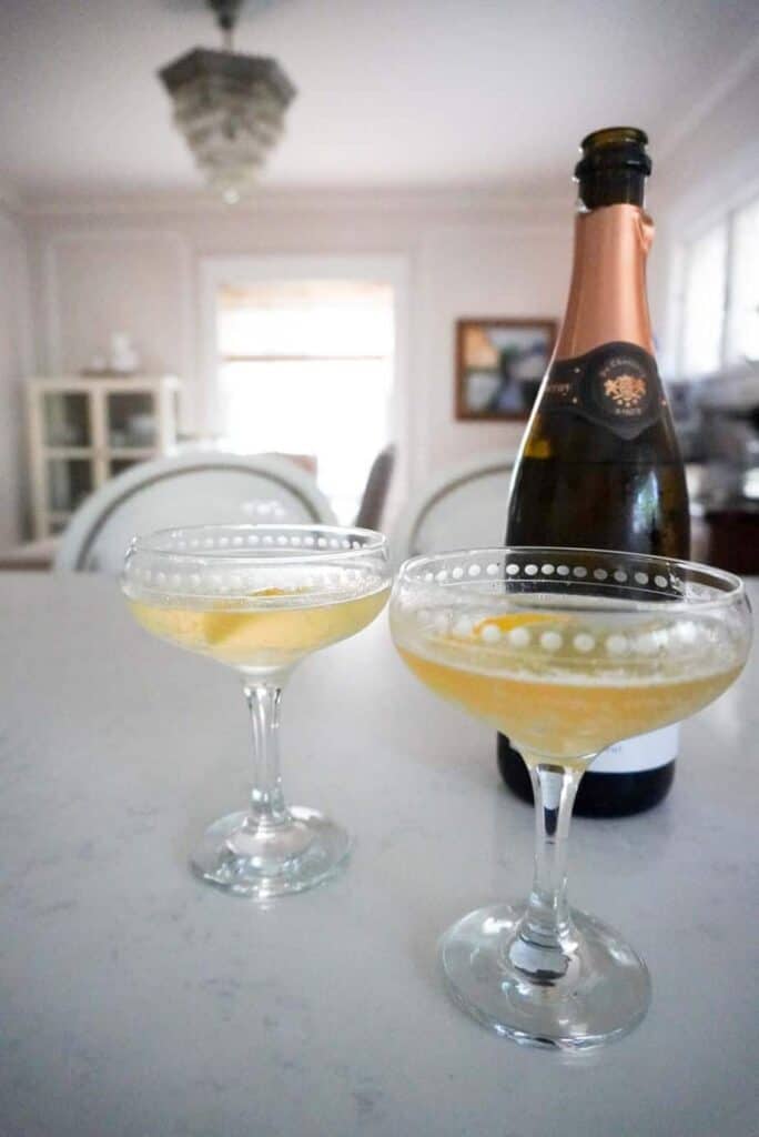 French 75 cocktails in a coupe on a counter | French Fridays Week 20