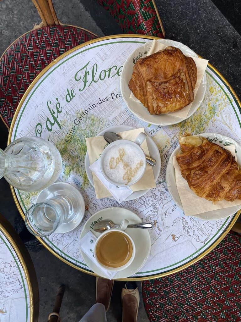 coffee and croissant on table of cafe de flore in paris.
