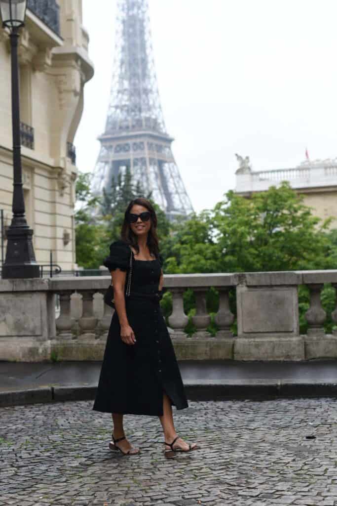 Walking down cobble stone street with Eiffel Tower in background