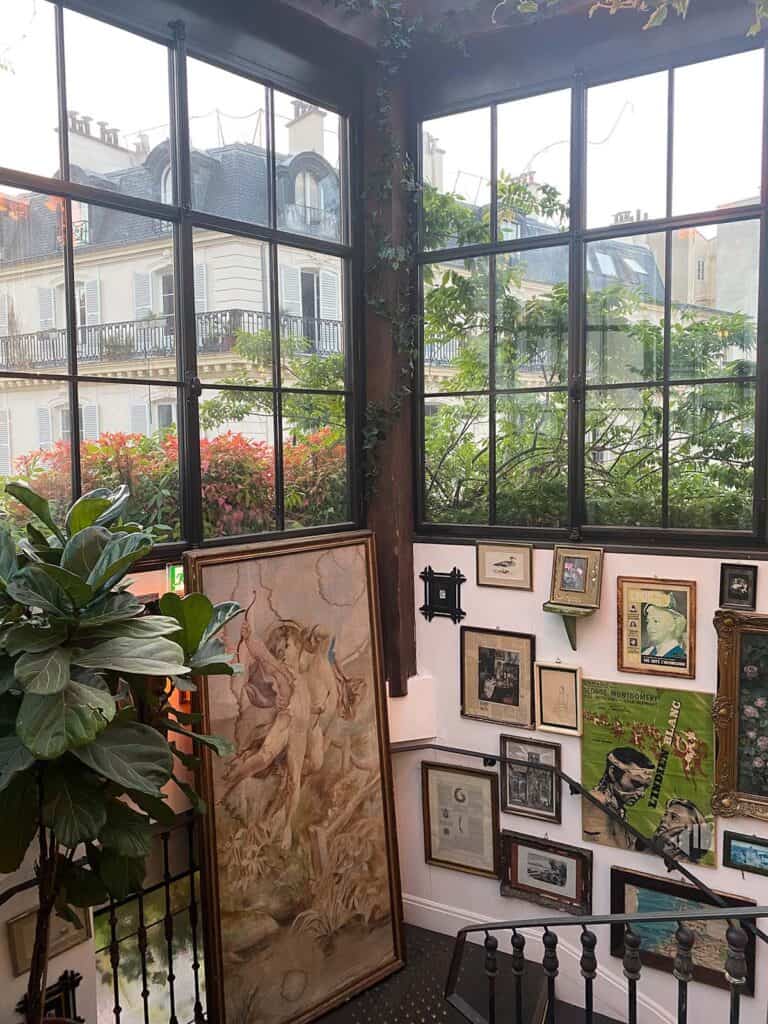 gallery wall at pink mamma in paris with paris facades in the background 