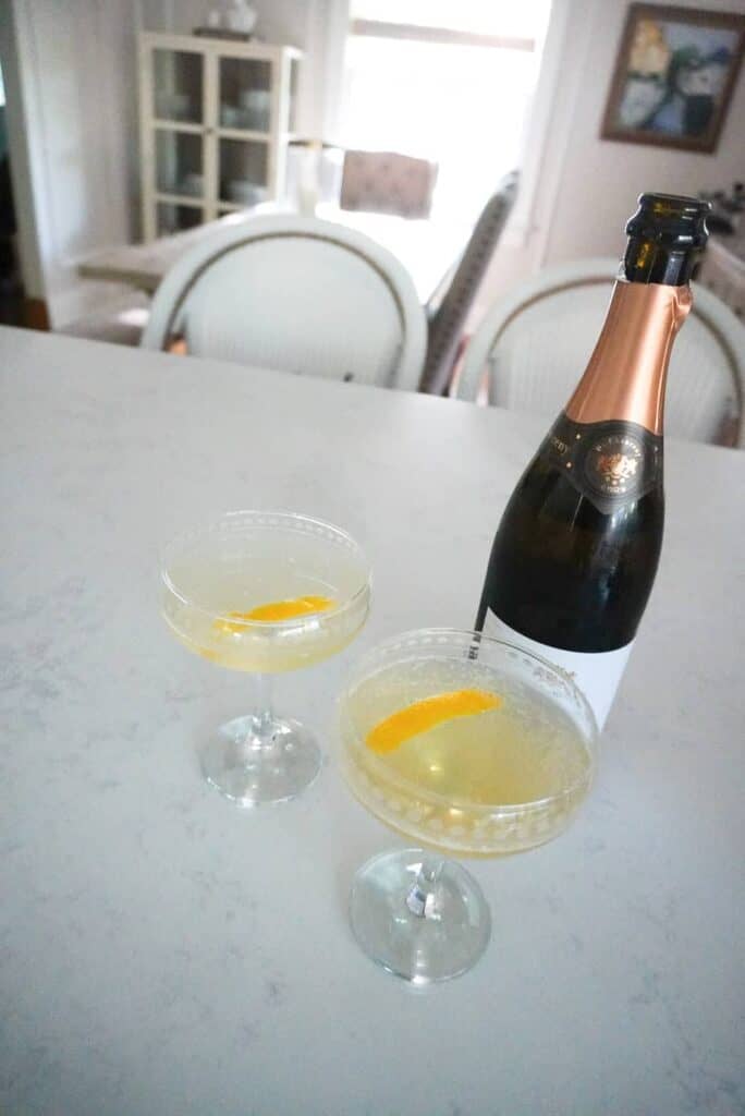 two french 75 cocktails sitting on a counter in a coupe