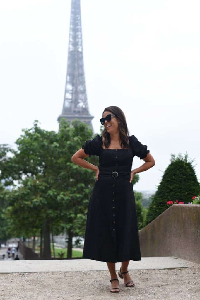 Laughing in front of Eiffel Tower in a black dress