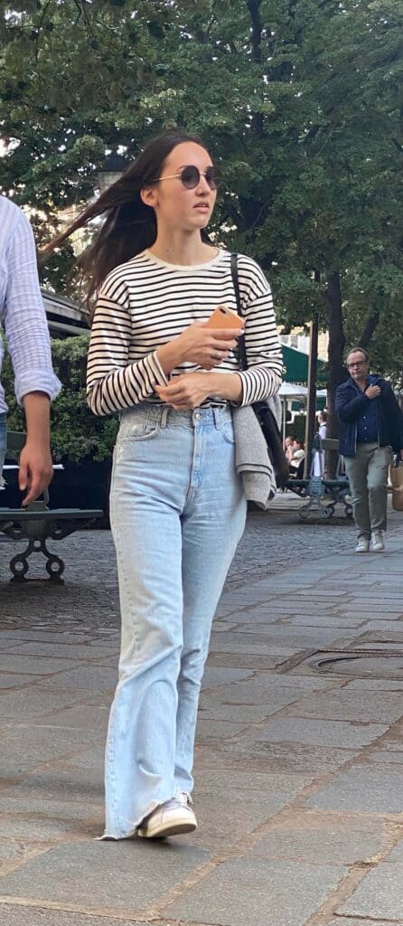 Parisian woman in stripe top with wide leg jeans