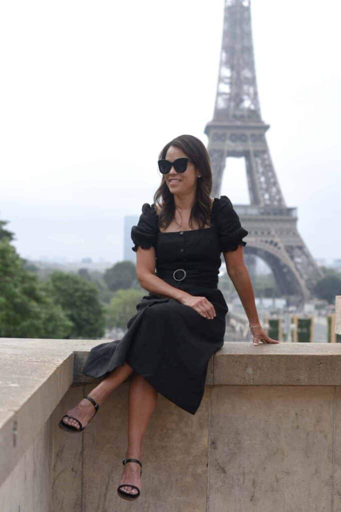 Sitting on concrete wall with Eiffel Tower in the background