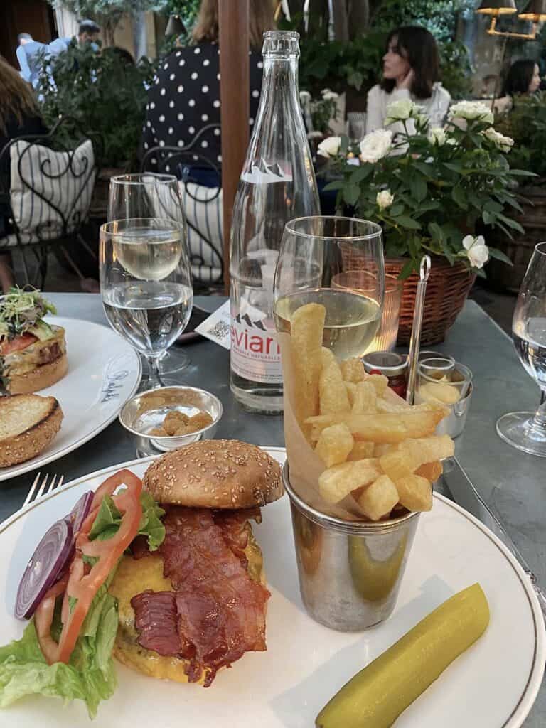 Burger and fries on a table at ralphs restaurant paris 