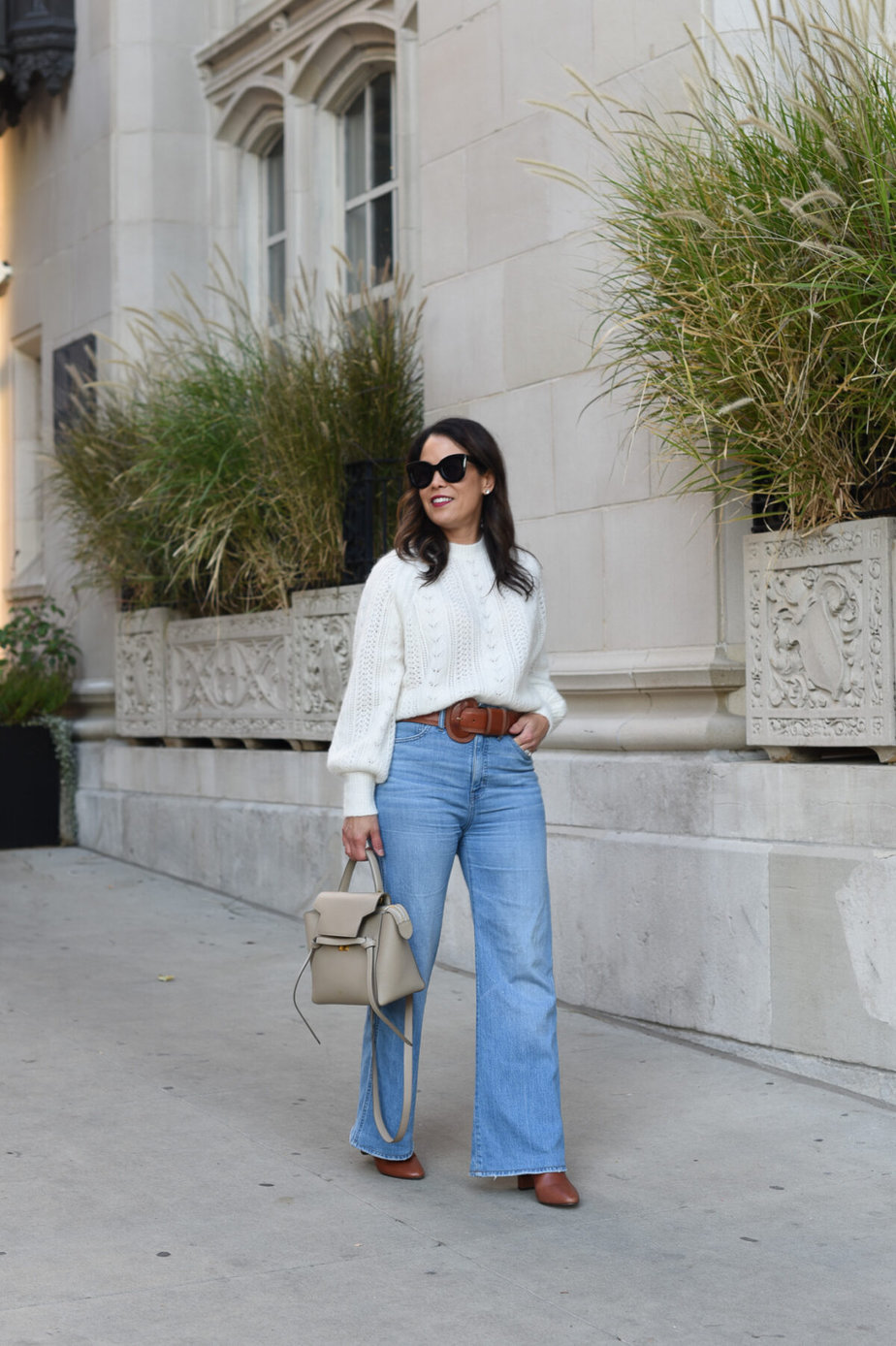 wearing white sweater with flare jeans
