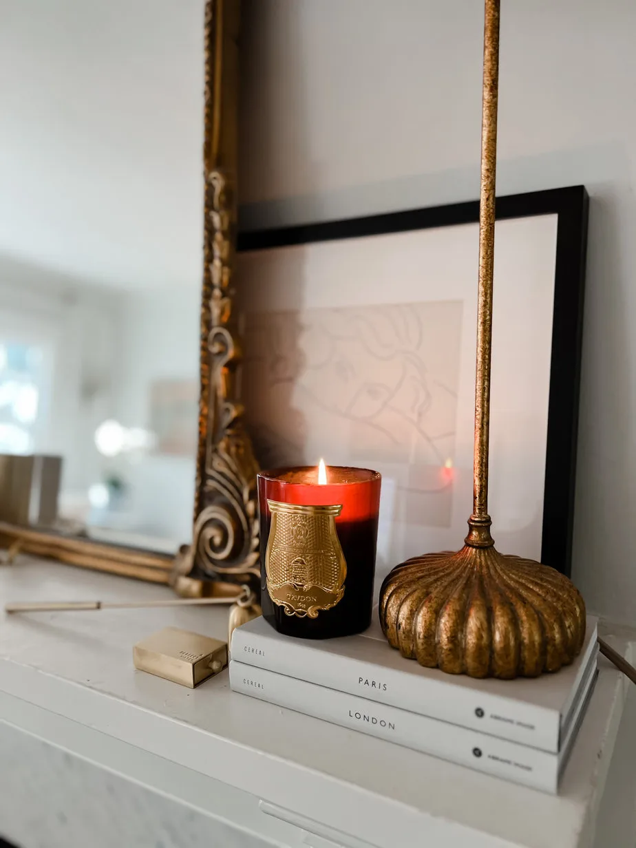 Red Candle for french fall sitting on a mantle