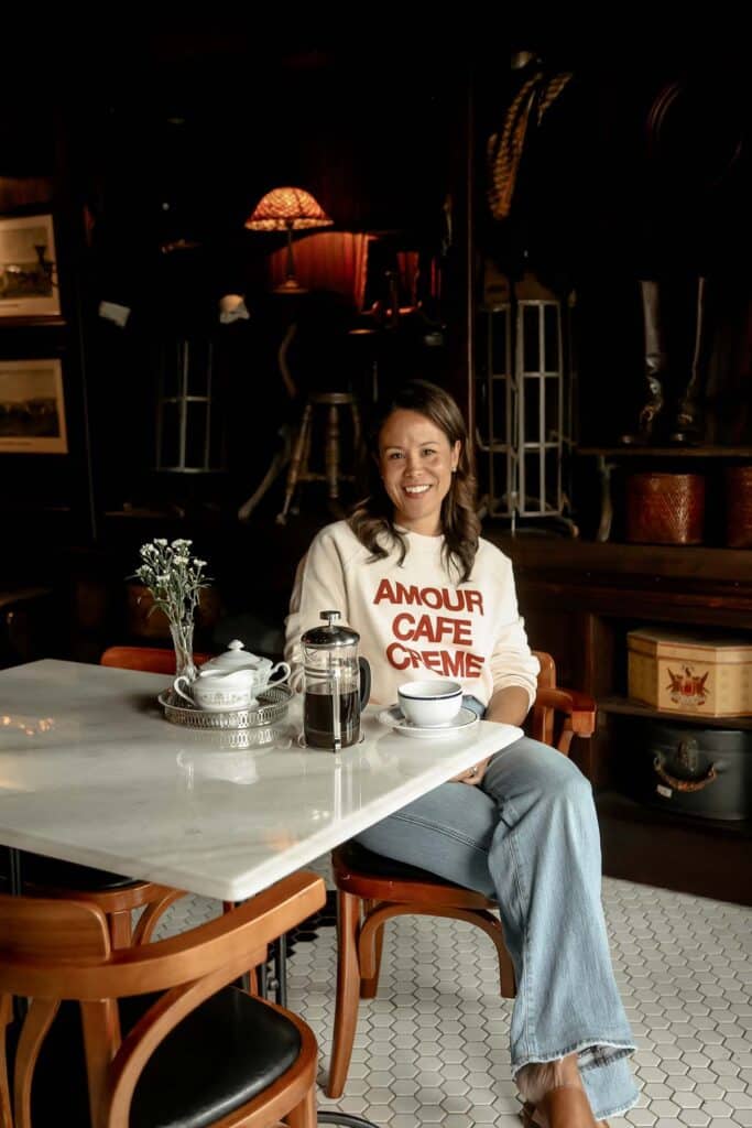 sitting in a restaurant with white marble table and holding coffee cup