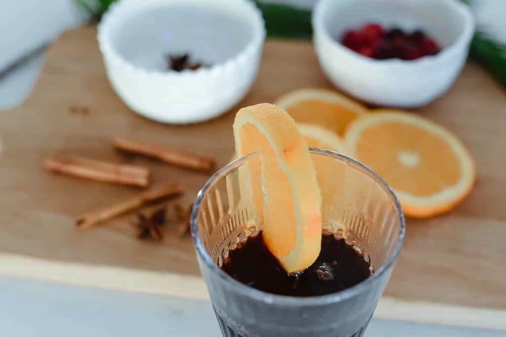 orange slice orange slice atop a glass on vin chaud sitting on counter