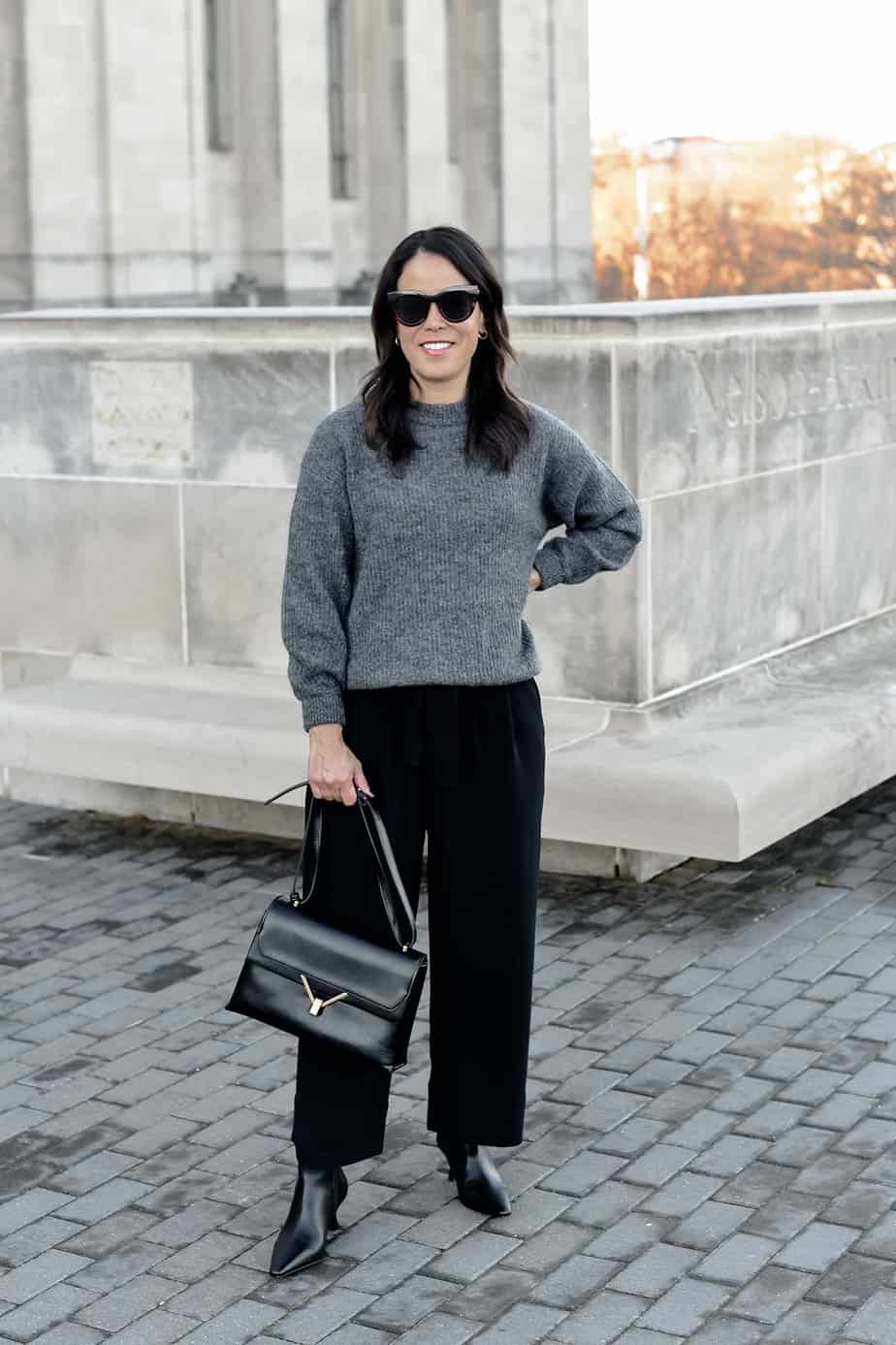 standing wearing everlane cashmere crew with black pants