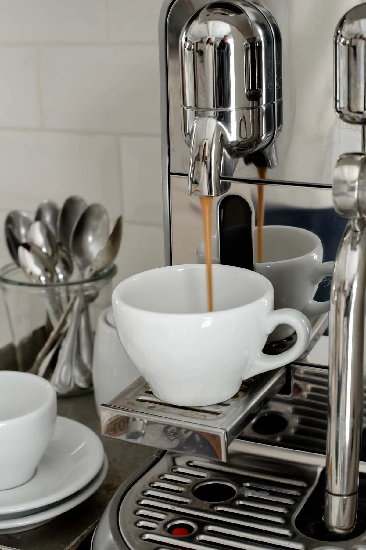 Espresso pouring into empty into espresso cup
