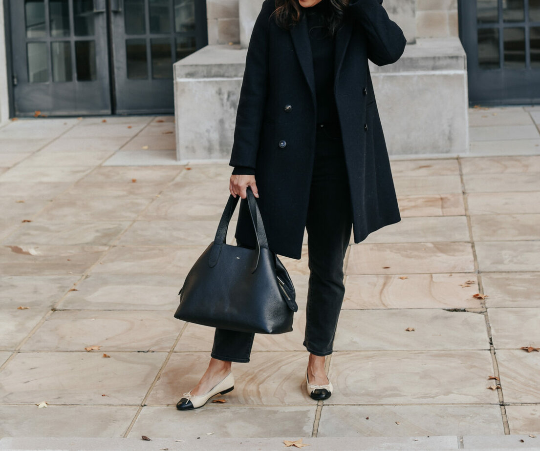 wearing chanel flats with navy coat and black pants
