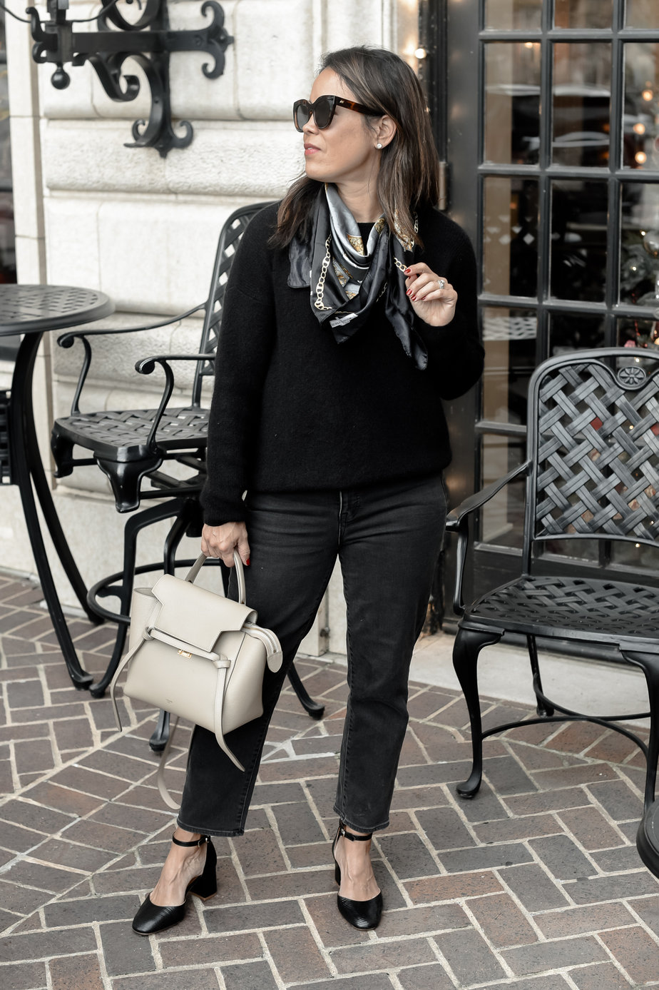 wearing all black sweater, scarf, and jeans