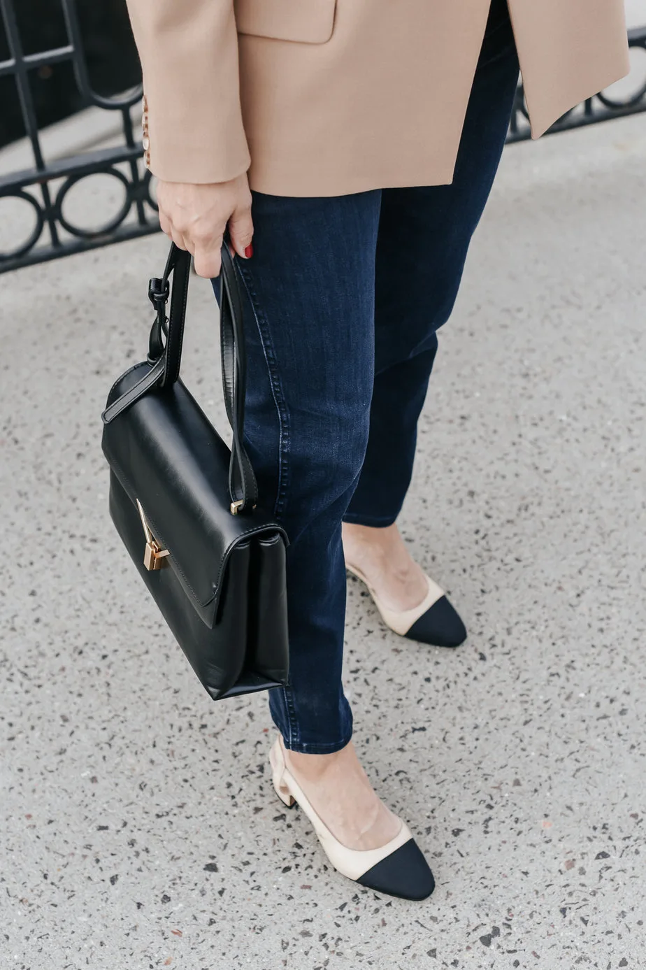 jeans, pumps, and holding black purse wearing camel blazer