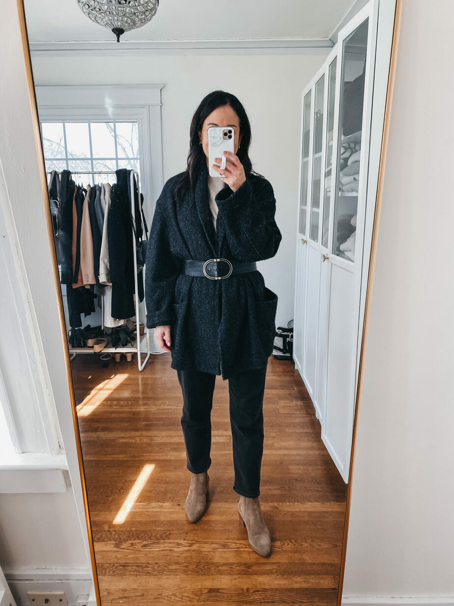 Wearing wool jacket with belt at waist and black jeans