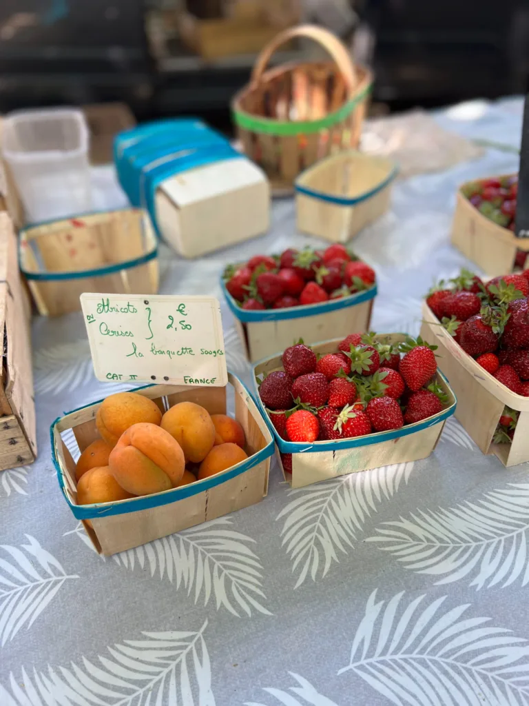 Apricots and Strawberries on a table.