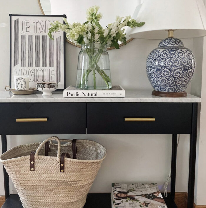 flowers on a marble console table with straw basket