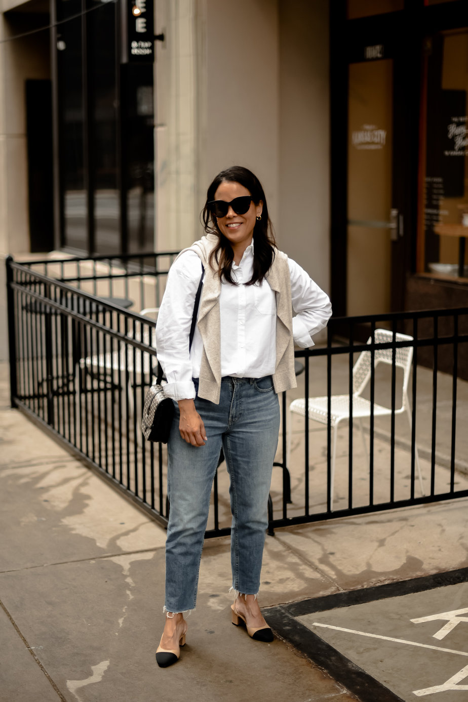 wearing sweater, white button down, jeans