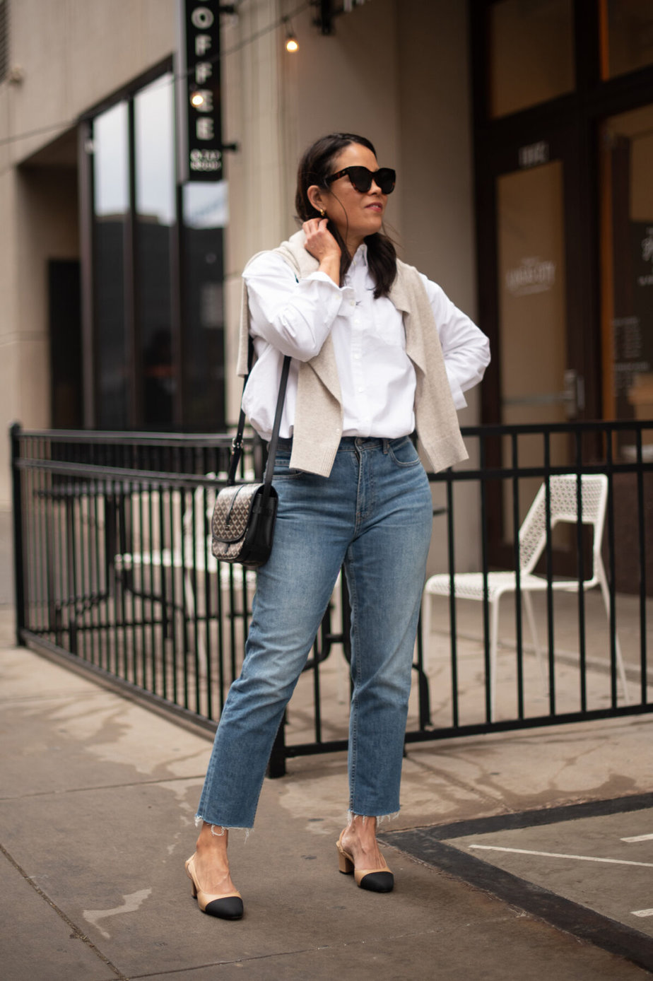 wearing sweater, white button down, jeans, and slingbacks.