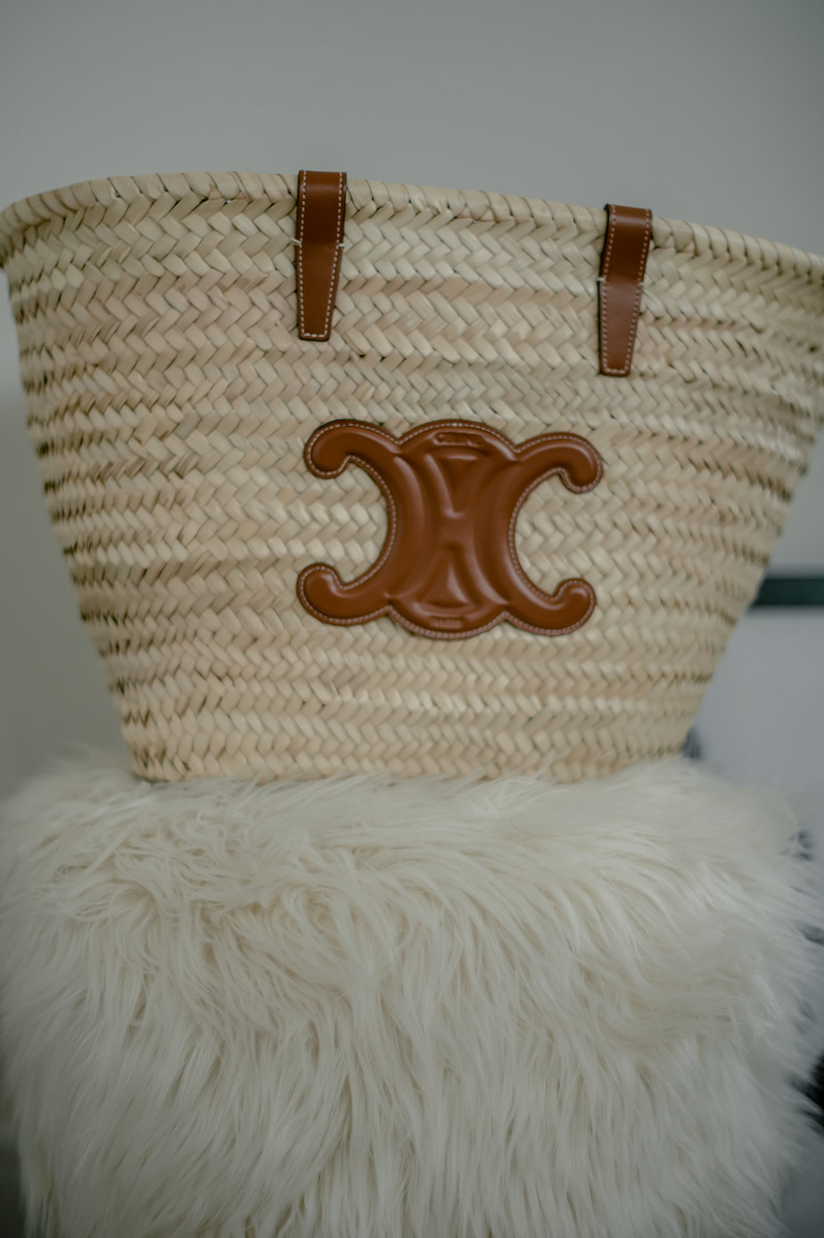 Celine Panier Tote sitting on a fuzzy stool