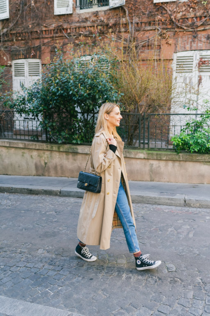 lady wearing trench coat with black converse