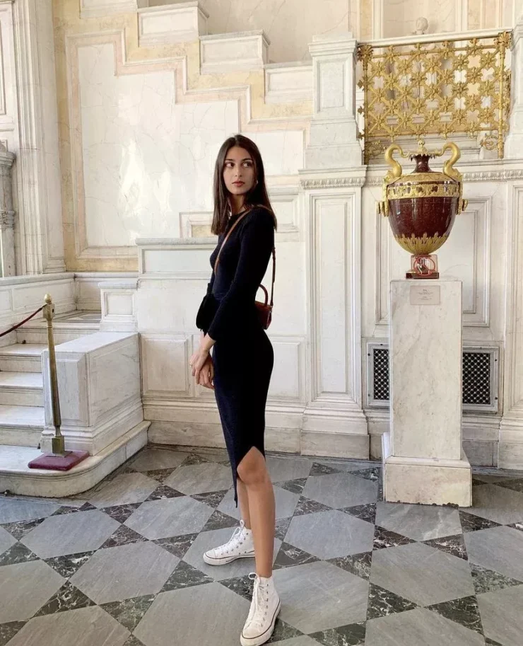 salome mory wearing black dress and sneakers