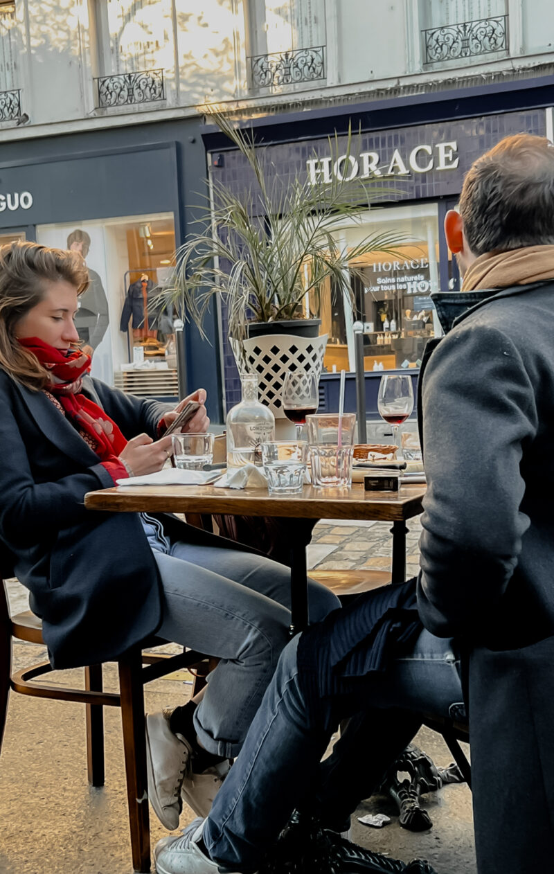 girl with navy coat and red scarf in Paris