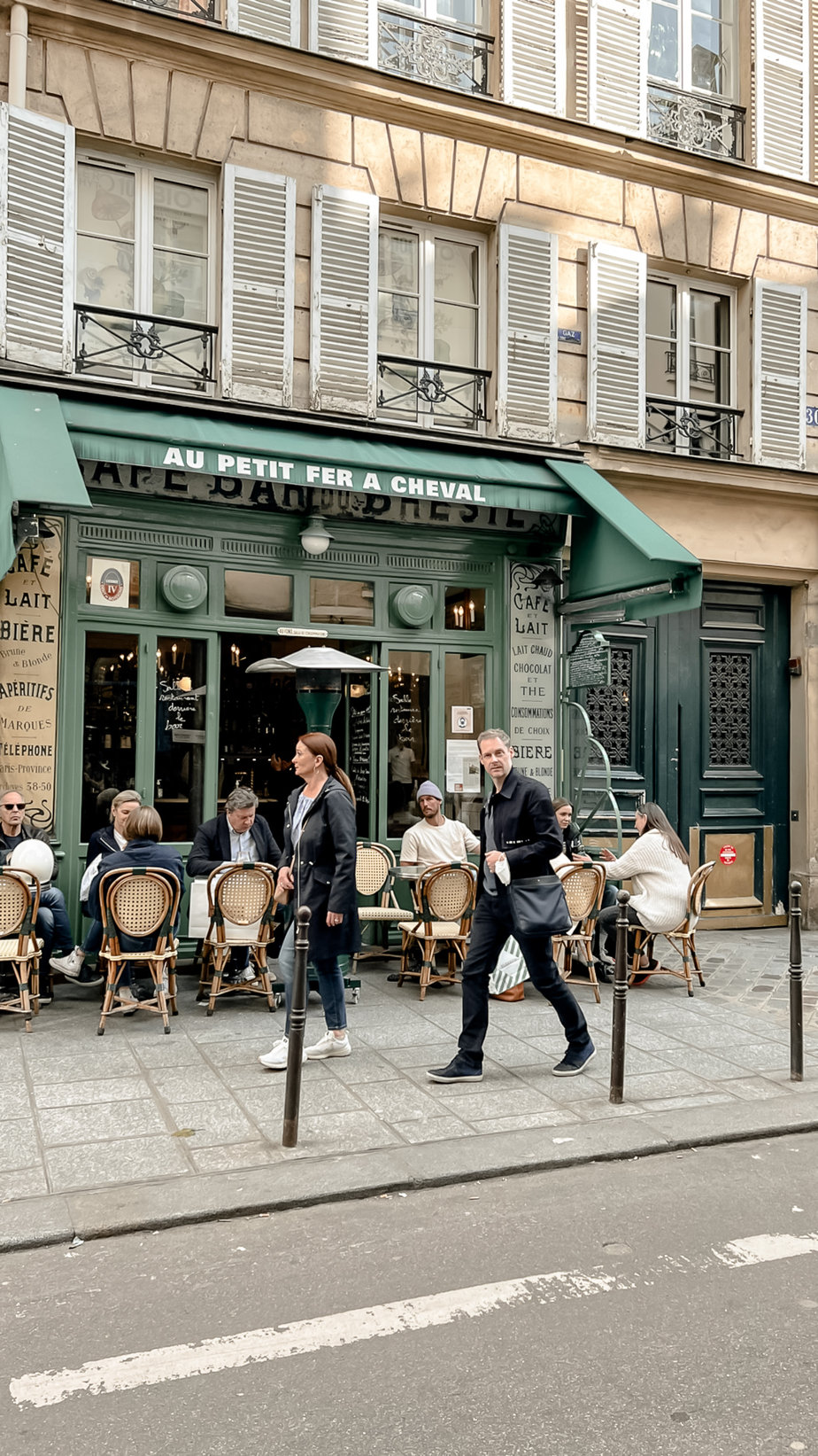 people walking in front of green building in paris