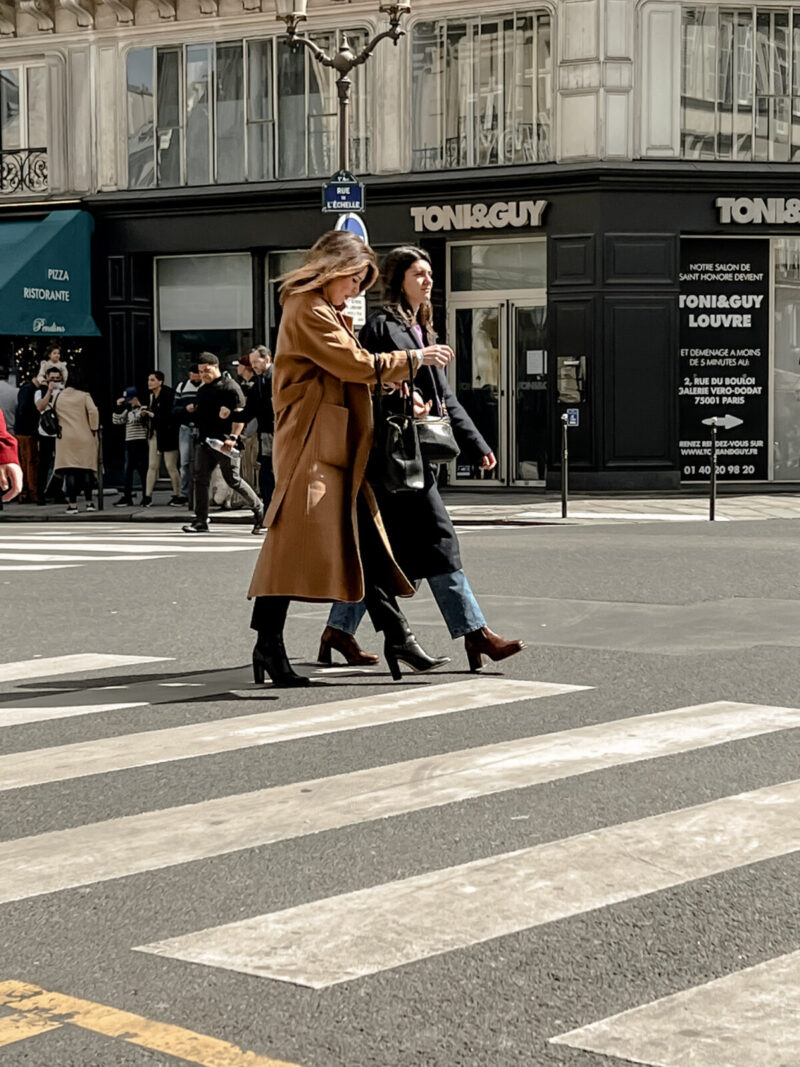two ladies walking across the street in Paris