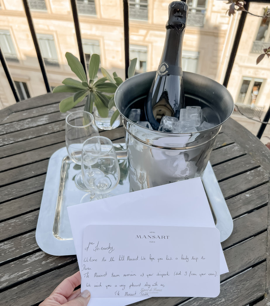 written note with bottle of champagne