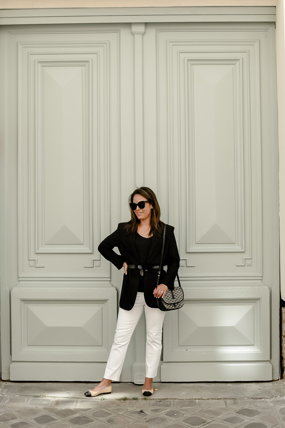 standing in front of green door in paris 