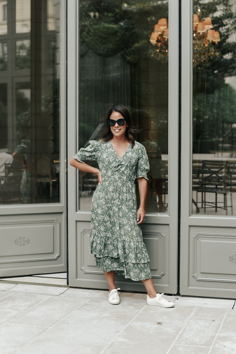standing with green dress in front of a green door
