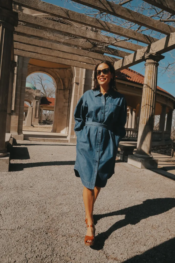 Woman with denim dress and clogs walking