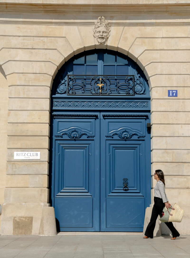 walking in front of blue door in Paris