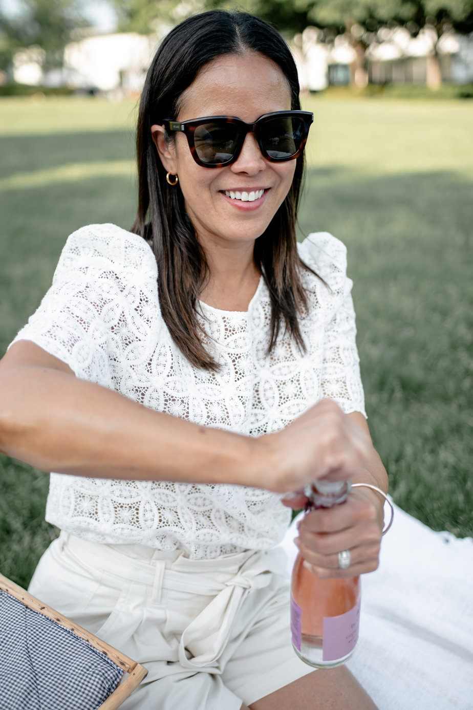 opening a bottle of champagne | How To Create Your Own French Inspired Picnic