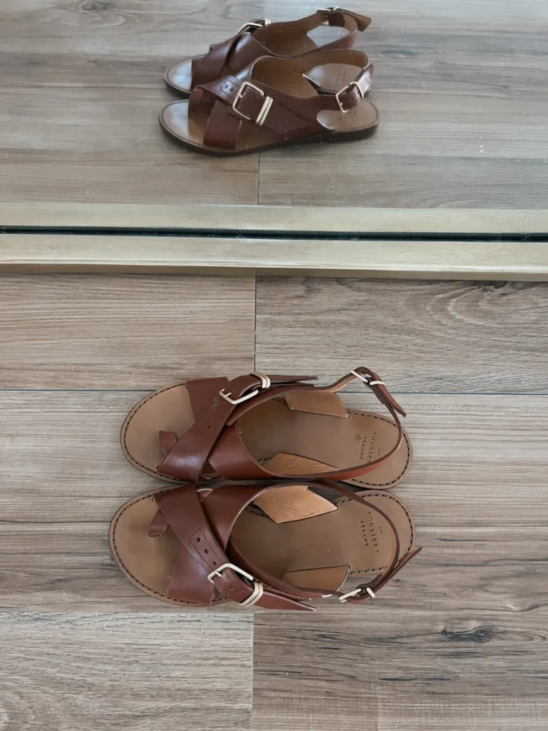 Brown sandals sitting on the floor.