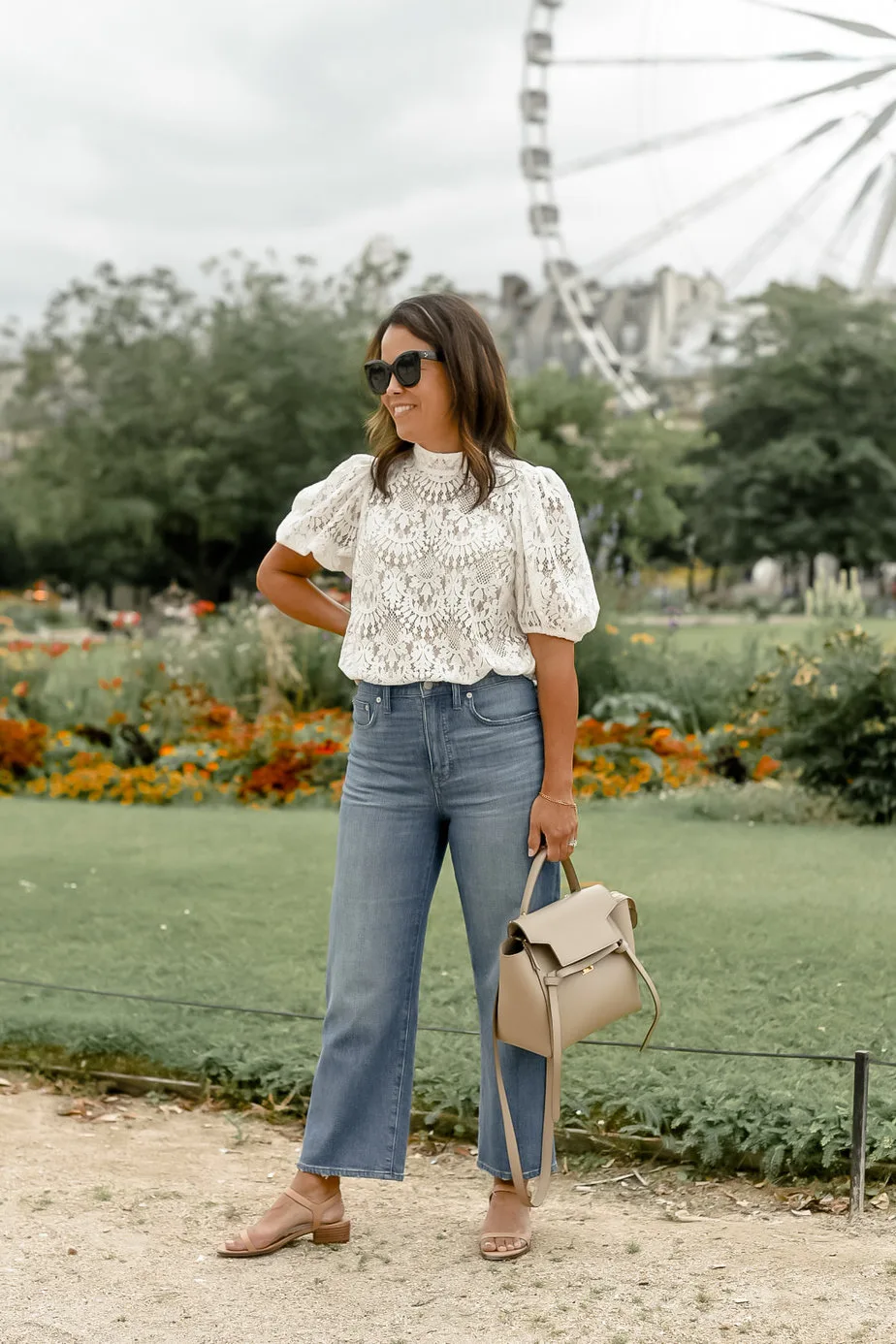 white top with jeans and purses in tuileries garden