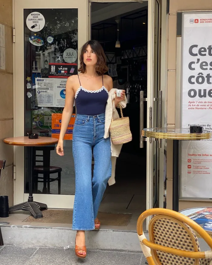 jeanne damas in navy tank and blue jeans
