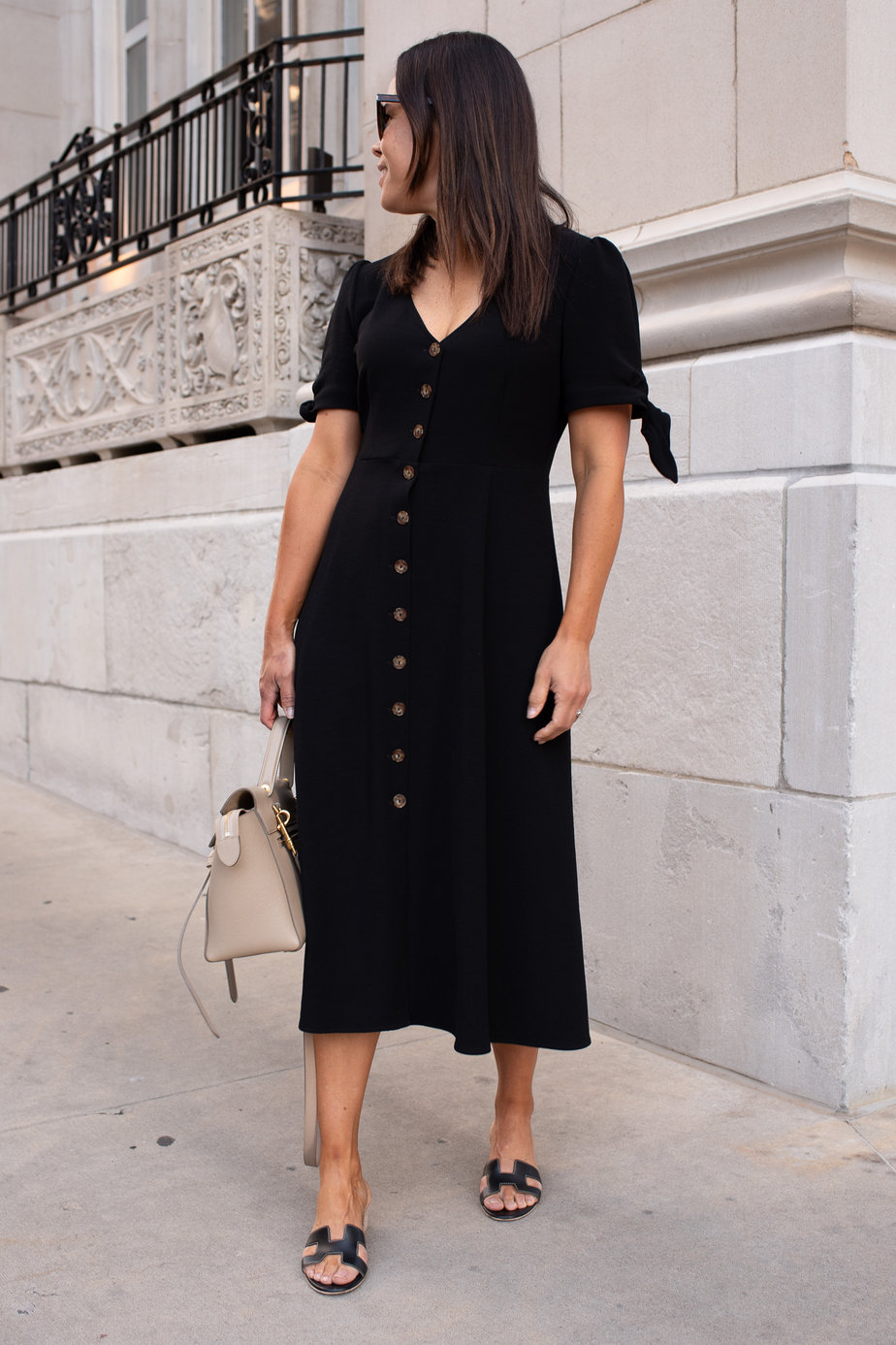 Wearing black dress walking down the street