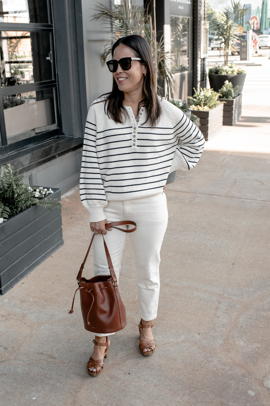 Wearing Sèzane Leontine With White Jeans In Front Of A Restaurant