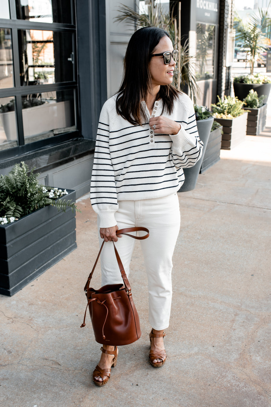 Wearing Sèzane Leontine With White Jeans In Front Of A Restaurant
