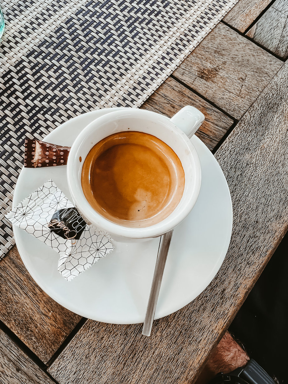 Espresso and saucer sitting on a table 