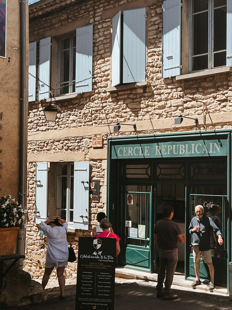 Cafe in Gordes France Cafe in Gordes France with Green Awning and blue shutters