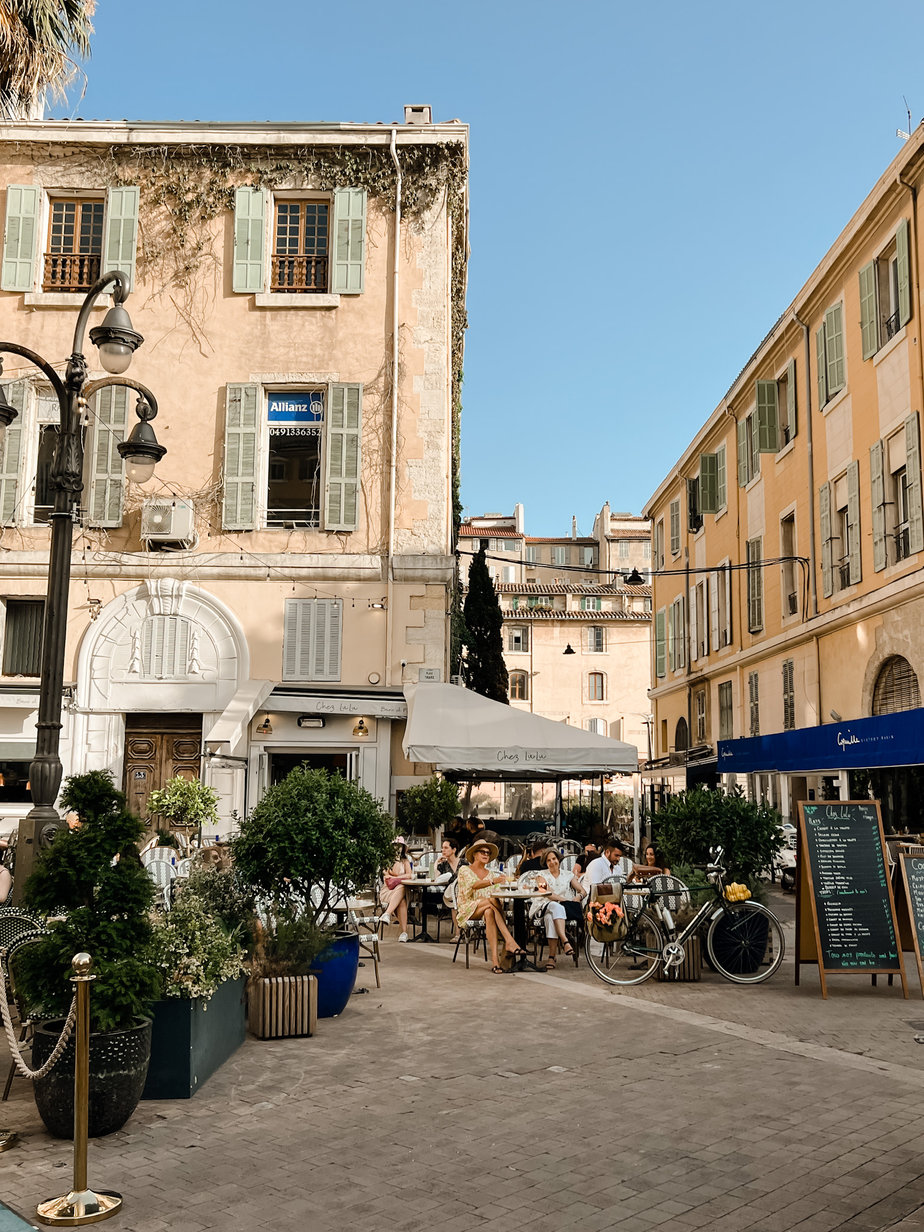 Courtyard in Marseille France with people sitting outside