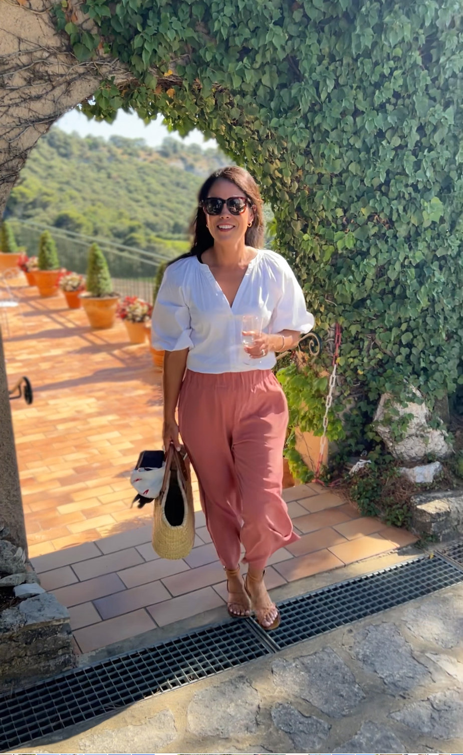 Cuyana Wide Leg pants with a white top and sandals in Provence 