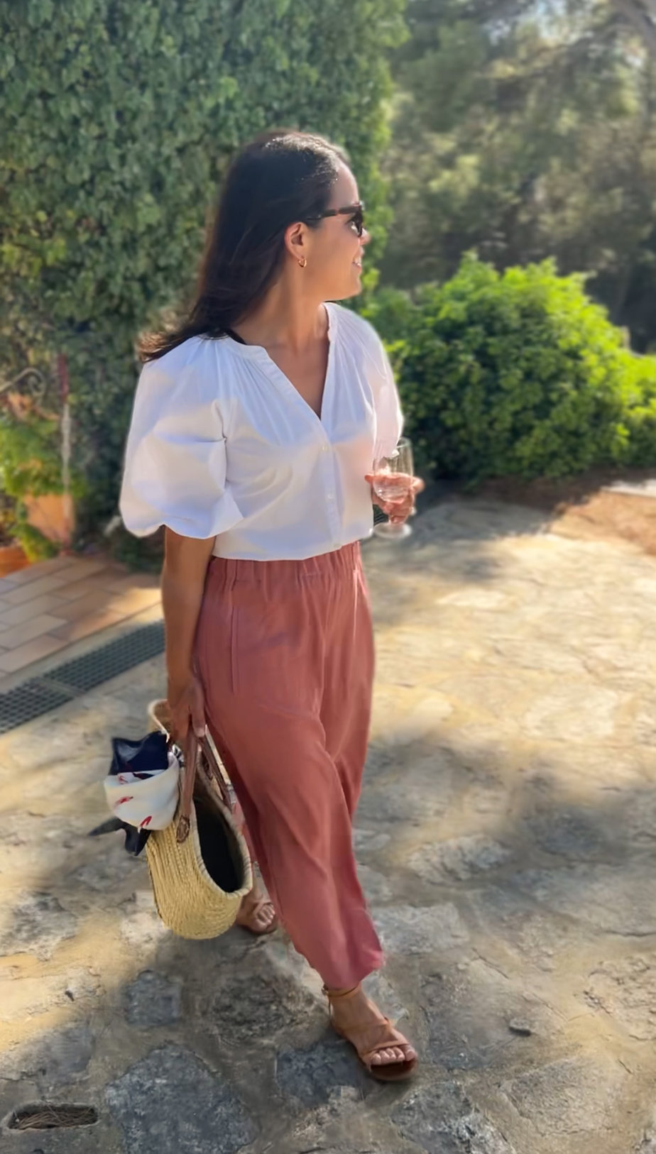 Wearing silk cuyana pants with a white top in Provence at a winery 