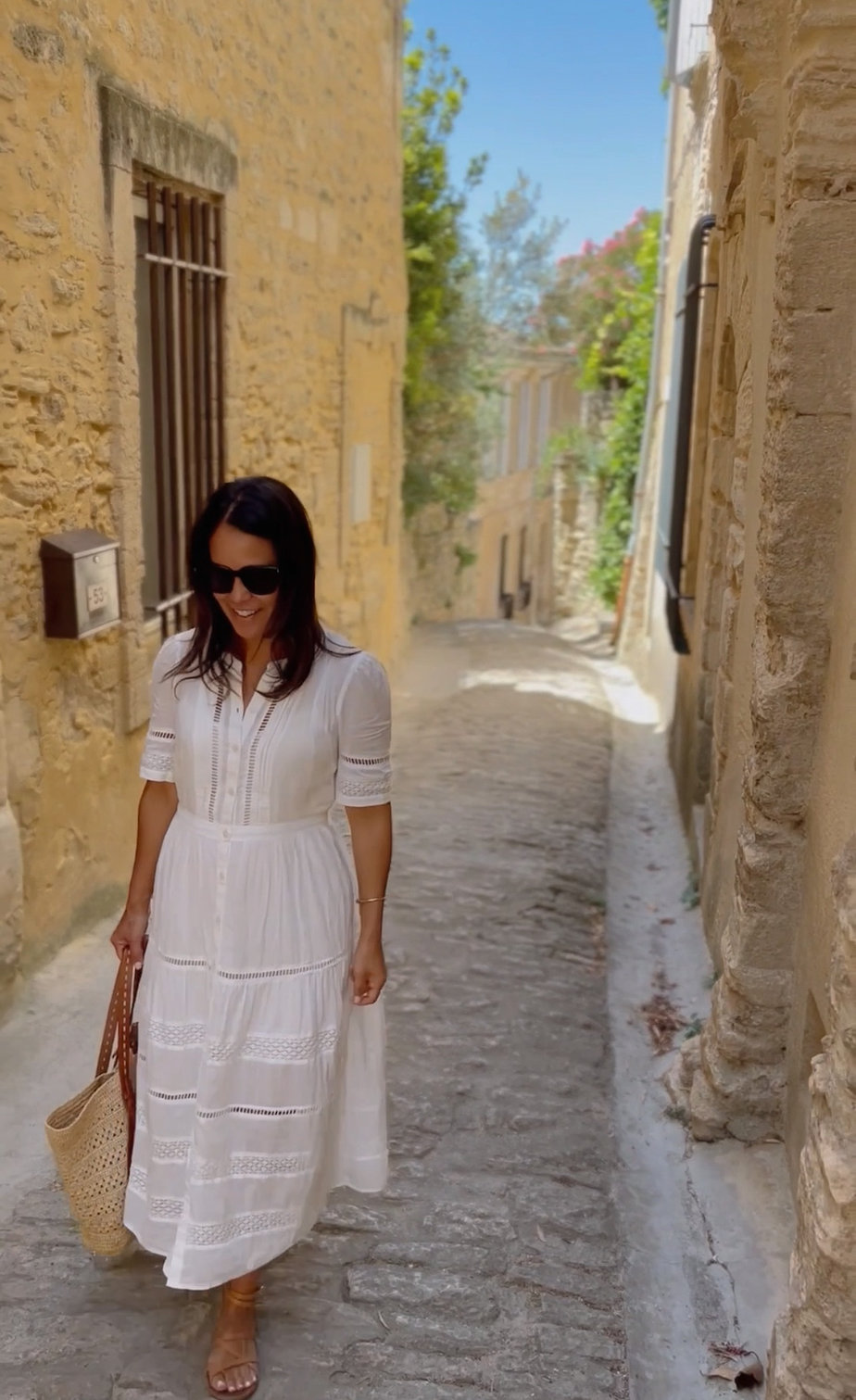 Wearing white eyelet dress walking in Gordes