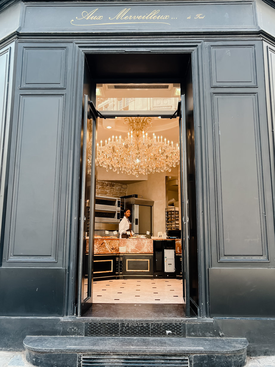 Looking inside to store with chandelier 