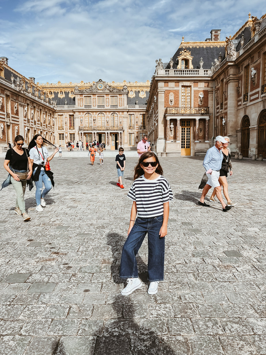 Versailles tourist Little girl standing in front of Versailles