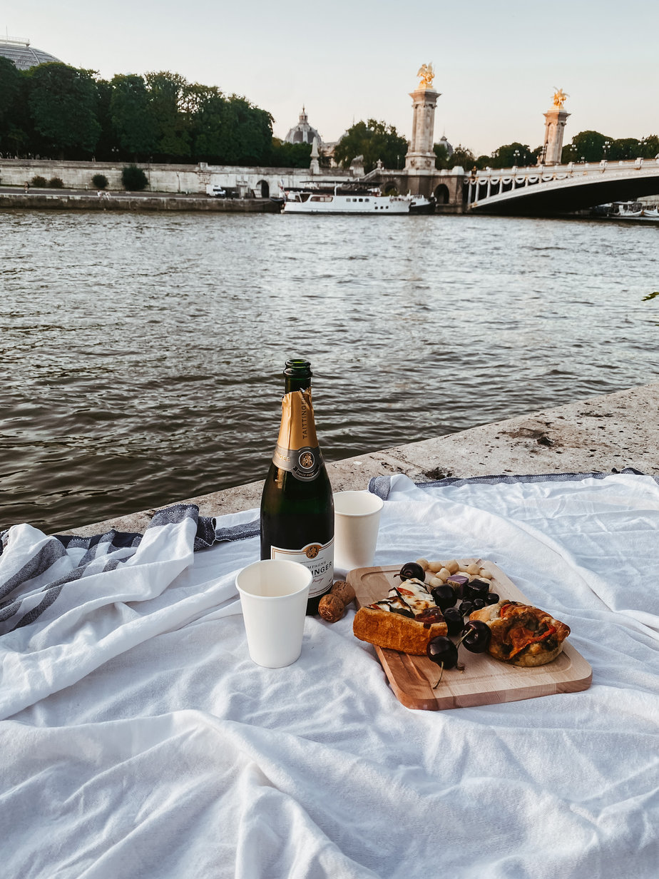food and wine at a picnic on the seine 
